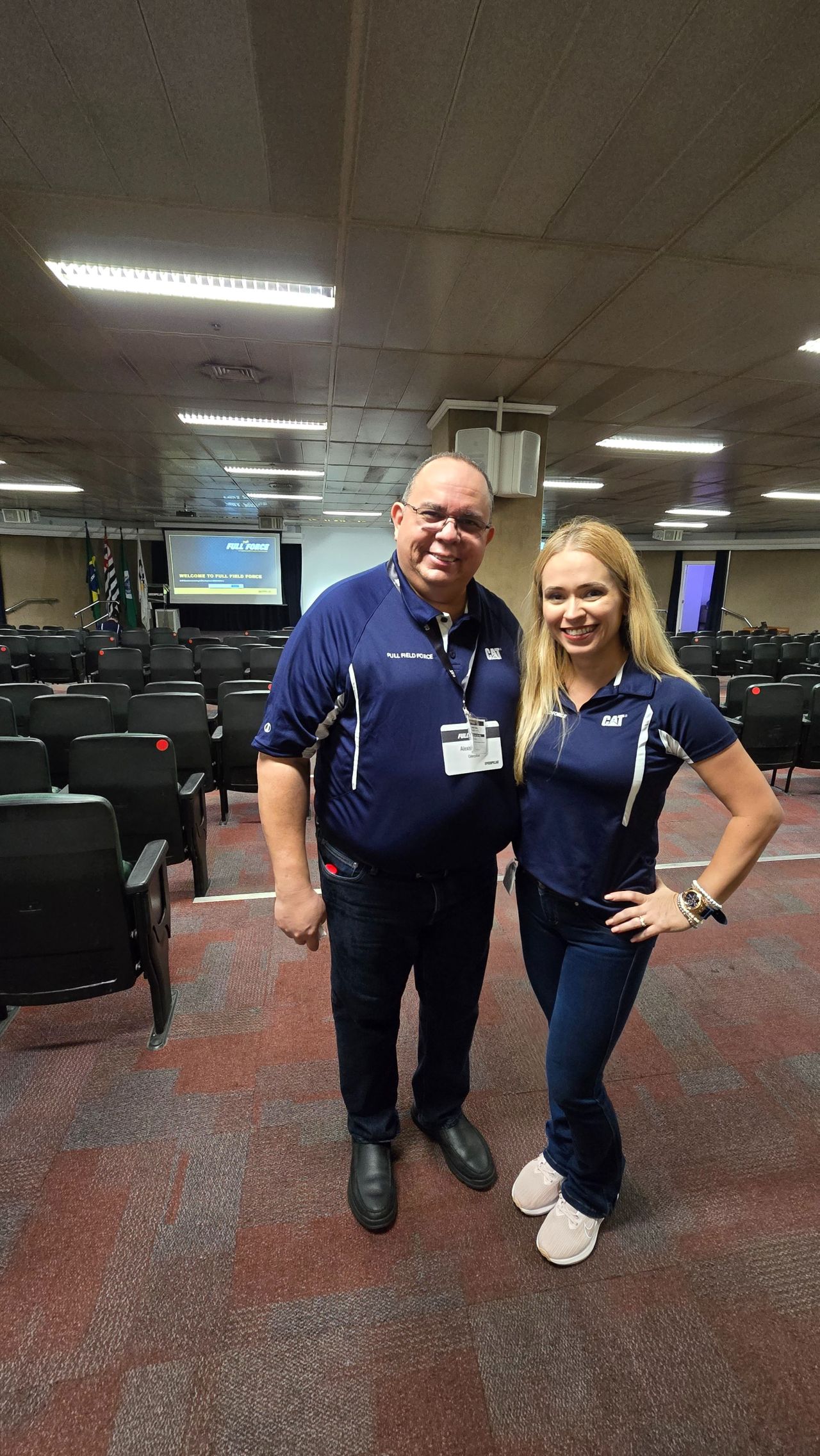 Madeline speaking on stage at a training event